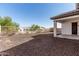 Gravel backyard with fence and covered patio of a modern home at 11915 S 184Th Ave, Goodyear, AZ 85338