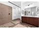 Bathroom features a double sink vanity, large mirror, and a glass-enclosed shower at 11915 S 184Th Ave, Goodyear, AZ 85338