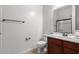 Well-lit bathroom showcases a vanity with cherry wood cabinets and modern fixtures at 11915 S 184Th Ave, Goodyear, AZ 85338