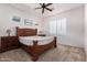 The bedroom features a ceiling fan, side tables with lamps, and coordinated decor at 11915 S 184Th Ave, Goodyear, AZ 85338