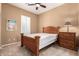 Comfortable bedroom with a ceiling fan and ample natural light from a window with shutters at 11915 S 184Th Ave, Goodyear, AZ 85338