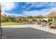 Relaxing common area featuring benches, mature trees, landscaping and walking path at 11915 S 184Th Ave, Goodyear, AZ 85338