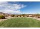 Scenic view of the tee box overlooking the golf course, desert landscape and mountains at 11915 S 184Th Ave, Goodyear, AZ 85338