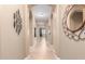 Long hallway featuring arched entryways and neutral decor, tile flooring, wall art at 11915 S 184Th Ave, Goodyear, AZ 85338