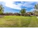 Expansive lush green lawn area with mature trees and well-maintained landscaping at 11915 S 184Th Ave, Goodyear, AZ 85338