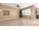 Bright, empty living area with tile flooring, plantation shutters, and designer accents at 11915 S 184Th Ave, Goodyear, AZ 85338