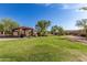 Community park featuring manicured lawn, trees, ramada, and scenic walking path at 11915 S 184Th Ave, Goodyear, AZ 85338