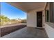 Covered patio with concrete floor and view of gravel yard and fence at 11915 S 184Th Ave, Goodyear, AZ 85338