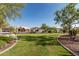 Well-maintained street view with green lawns and beautiful homes at 11915 S 184Th Ave, Goodyear, AZ 85338