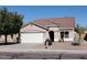 Charming single-story home featuring a two-car garage and low maintenance desert landscaping at 13480 W Canyon Creek Dr, Surprise, AZ 85374