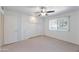 Well-lit bedroom features a built-in closet, neutral carpet, and bright window at 13620 N Hawthorn Dr, Sun City, AZ 85351