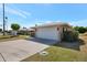 Home exterior featuring a two-car garage, well-kept lawn, and a charming neighborhood setting at 13620 N Hawthorn Dr, Sun City, AZ 85351