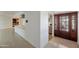 Inviting foyer featuring a decorative wood door and seamless transition to the open living spaces at 13620 N Hawthorn Dr, Sun City, AZ 85351