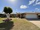 Inviting home with a pergola-covered entrance, solar panels, and manicured front yard at 13620 N Hawthorn Dr, Sun City, AZ 85351