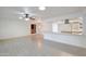 Bright living room with ceiling fan, tile floors, and eat-in kitchen perfect for modern living at 13620 N Hawthorn Dr, Sun City, AZ 85351