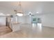 Bright and spacious living room with tile floors, modern lighting, and open floor plan at 13620 N Hawthorn Dr, Sun City, AZ 85351