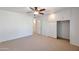 Comfortable main bedroom with ceiling fan, neutral carpet, closet, and ensuite access at 13620 N Hawthorn Dr, Sun City, AZ 85351