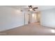 Bright, airy main bedroom with ceiling fan, neutral carpet, and access to closet and ensuite at 13620 N Hawthorn Dr, Sun City, AZ 85351