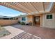 Welcoming patio with a pergola, brick flooring, and lush greenery, perfect for outdoor relaxation at 13620 N Hawthorn Dr, Sun City, AZ 85351