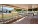 Relaxing covered patio featuring tile flooring, wrought iron railing, outdoor table and chairs, plus a hot tub and TV at 13620 N Hawthorn Dr, Sun City, AZ 85351