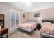 Bedroom featuring carpeted floors, neutral walls, and shuttered windows at 15227 N Rosewood Dr, Sun City, AZ 85351