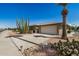 Inviting home with desert landscaping, a large garage, and a generously sized driveway at 15227 N Rosewood Dr, Sun City, AZ 85351