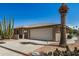 Attractive home boasting a large garage, desert landscaping, and an extra wide driveway at 15227 N Rosewood Dr, Sun City, AZ 85351