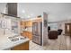 Traditional style kitchen with stainless steel appliances, breakfast bar, and laundry area at 15227 N Rosewood Dr, Sun City, AZ 85351