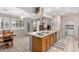 Open kitchen featuring an island with gas cooktop, stylish range hood, and adjacent dining space at 15227 N Rosewood Dr, Sun City, AZ 85351