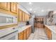 Bright kitchen featuring classic wood cabinetry, tiled floors, and modern appliances at 15227 N Rosewood Dr, Sun City, AZ 85351