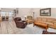 Comfortable living room featuring a sofa, recliner, and hardwood flooring in an open-concept layout at 15227 N Rosewood Dr, Sun City, AZ 85351