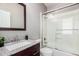 Bathroom with granite vanity and shower over tub with glass sliding door at 15322 W Montecito Ave, Goodyear, AZ 85395