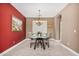 Elegant dining room with a glass table, comfortable seating, and a refined chandelier fixture at 15322 W Montecito Ave, Goodyear, AZ 85395