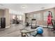 A home gym with treadmills, free weights, fitness ball, mirrored wall, and punching bag at 15322 W Montecito Ave, Goodyear, AZ 85395