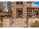 Welcoming front entrance with a stone walkway, decorative flower pots, and a stylish front door at 15322 W Montecito Ave, Goodyear, AZ 85395