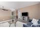 A cozy living room with grey tones, a ceiling fan, and a sofa at 15322 W Montecito Ave, Goodyear, AZ 85395