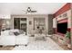 Bright living room with modern furnishings, decorative rug, and ceiling fan at 15322 W Montecito Ave, Goodyear, AZ 85395