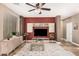 Comfortable living room features stylish built-ins, a ceiling fan, and tile flooring at 15322 W Montecito Ave, Goodyear, AZ 85395