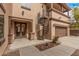 Side exterior view featuring a spiral staircase, a double-door entrance, and a well-maintained yard at 15322 W Montecito Ave, Goodyear, AZ 85395