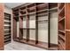 A spacious walk-in closet offers ample storage with custom shelves and racks at 15322 W Montecito Ave, Goodyear, AZ 85395