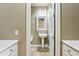 Powder room with pedestal sink and white cabinets at 15881 W Berkeley Rd, Goodyear, AZ 85395