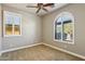 Bedroom with carpet, two windows with shutters, and ceiling fan at 15881 W Berkeley Rd, Goodyear, AZ 85395