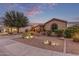 Home exterior with a landscaped front yard at dusk at 15881 W Berkeley Rd, Goodyear, AZ 85395