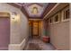 Inviting covered front entrance with tiled walkway and decorative potted plants at 15881 W Berkeley Rd, Goodyear, AZ 85395