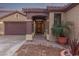 Inviting front entrance featuring a covered walkway and mature landscaping at 15881 W Berkeley Rd, Goodyear, AZ 85395