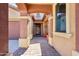 Covered entryway leading to the front door with stylish columns and landscaping at 15881 W Berkeley Rd, Goodyear, AZ 85395