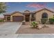 Charming single-story home with a well-manicured, low-maintenance desert landscape and a neutral color scheme at 15881 W Berkeley Rd, Goodyear, AZ 85395