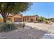 Charming single-story home with a well-manicured, low-maintenance desert landscape and a neutral color scheme at 15881 W Berkeley Rd, Goodyear, AZ 85395