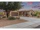 Beautiful single-story home with a driveway, two car garage, and low-maintenance desert landscaping at 15881 W Berkeley Rd, Goodyear, AZ 85395