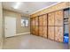 Garage with epoxy floor and custom wooden storage cabinets at 15881 W Berkeley Rd, Goodyear, AZ 85395